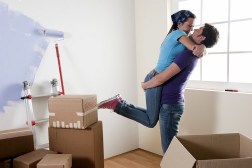Trained moving staff using safe lifting techniques with equipment