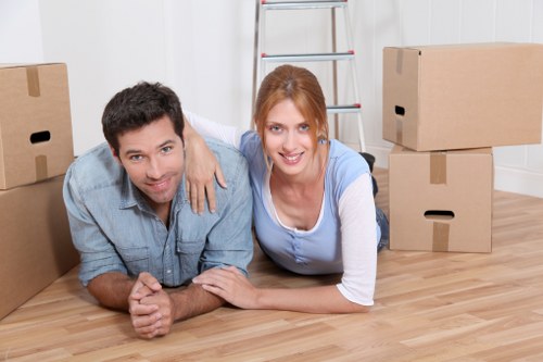Local removals team handling boxes and furniture in a Clapham flat move