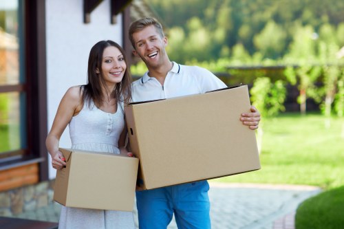 Packed moving boxes and furniture ready for transport in a Clapham home