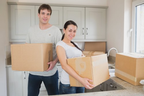 Packed boxes and furniture ready for removal in a Clapham property